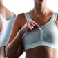 White sports bra worn by a person on a white background